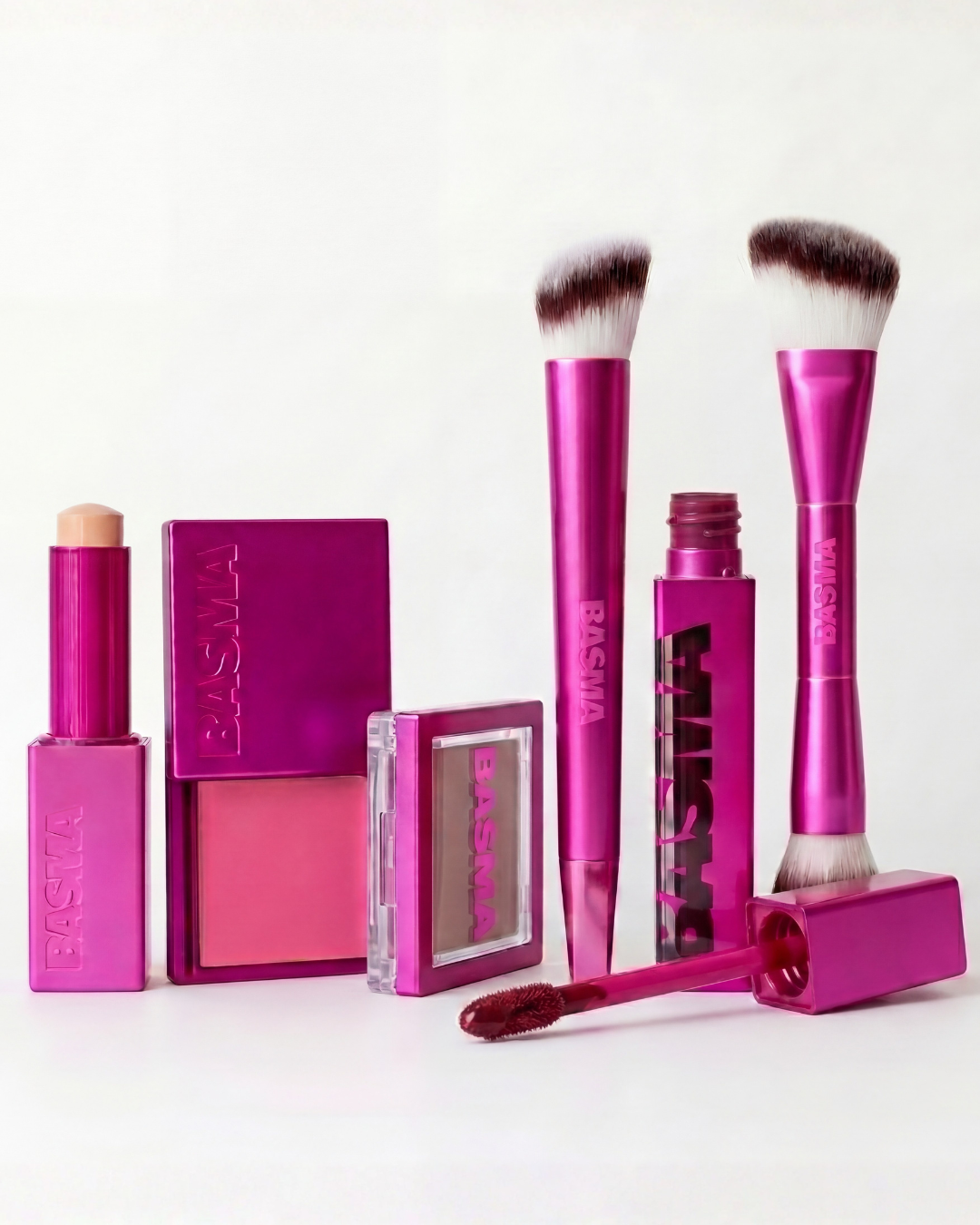 Makeup products including brushes and lipsticks with a visible brand on a white background